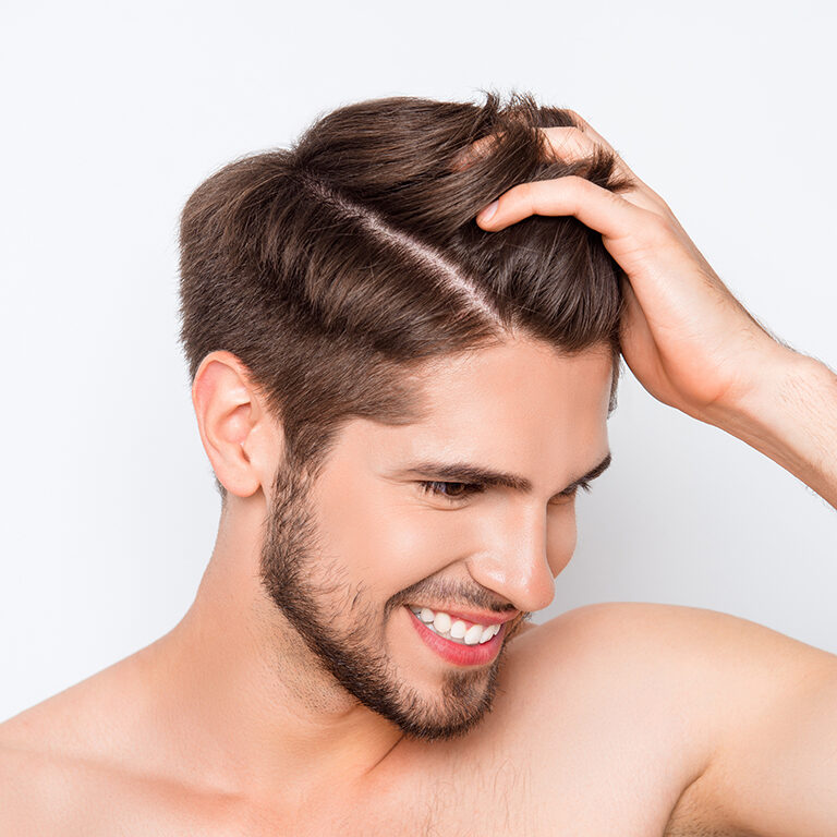 Portrait-of-smiling-man-showing-his-healthy-hair