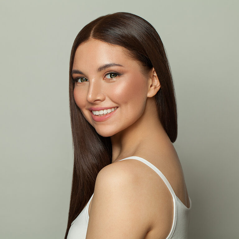 pretty-brunette-model-woman-with-clear-skin-and-long-healthy-straight-hair-smiling
